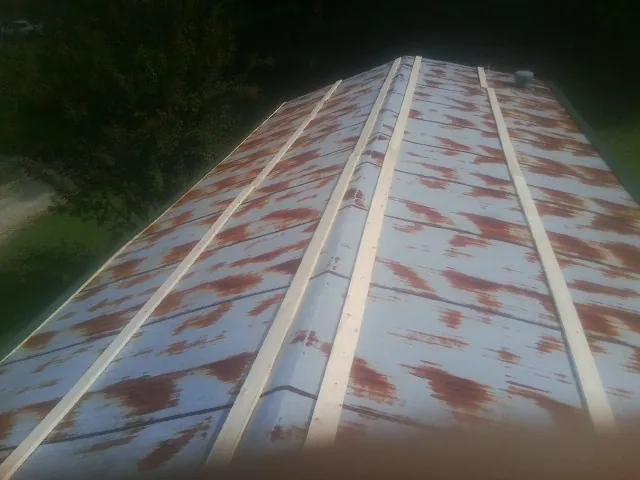 Rusted metal roof panels with new wood purlins before replacement — Storm Damage Roof Repair in Lewisburg by Roofing Brothers
